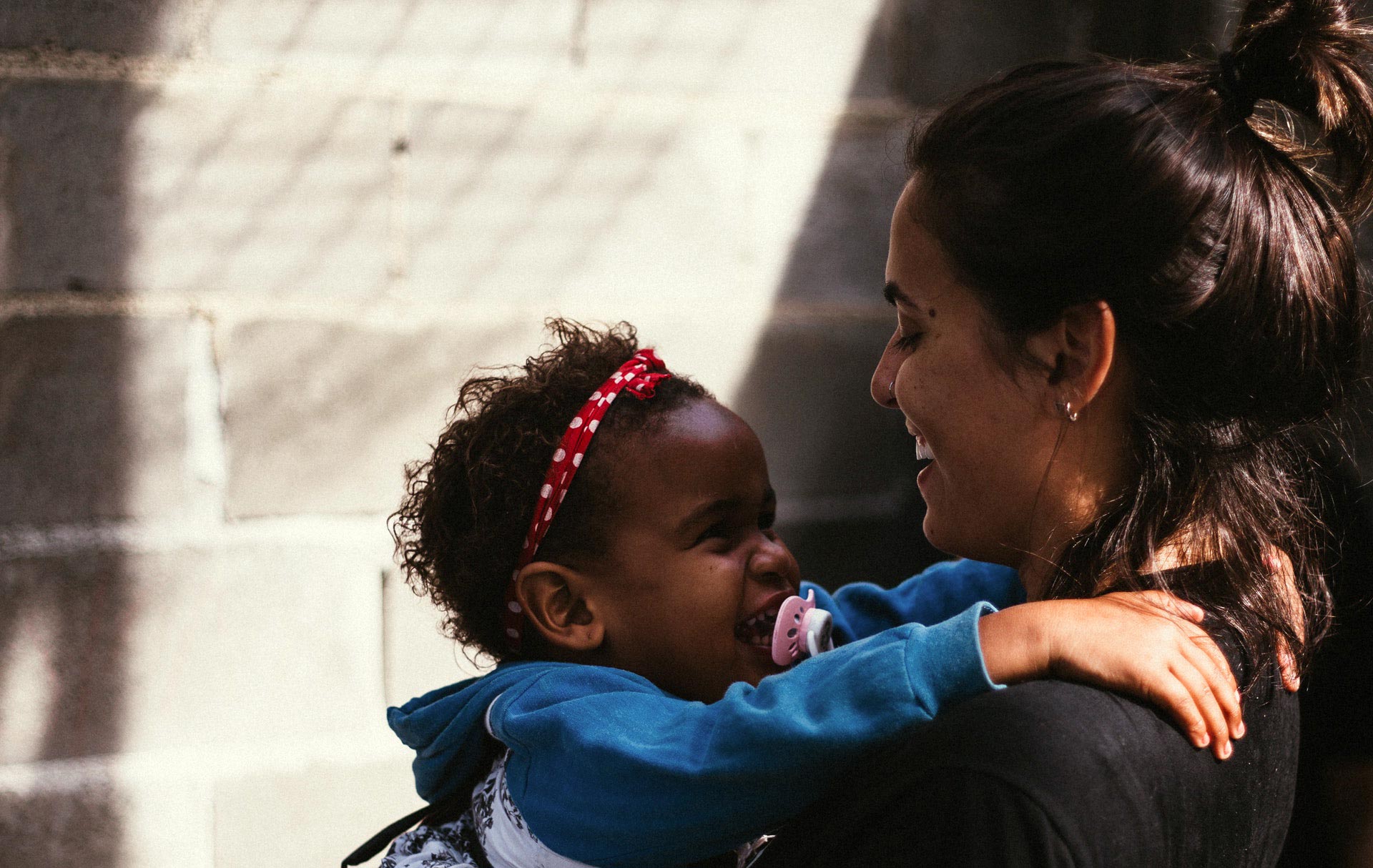 Smiling woman holding a happy child